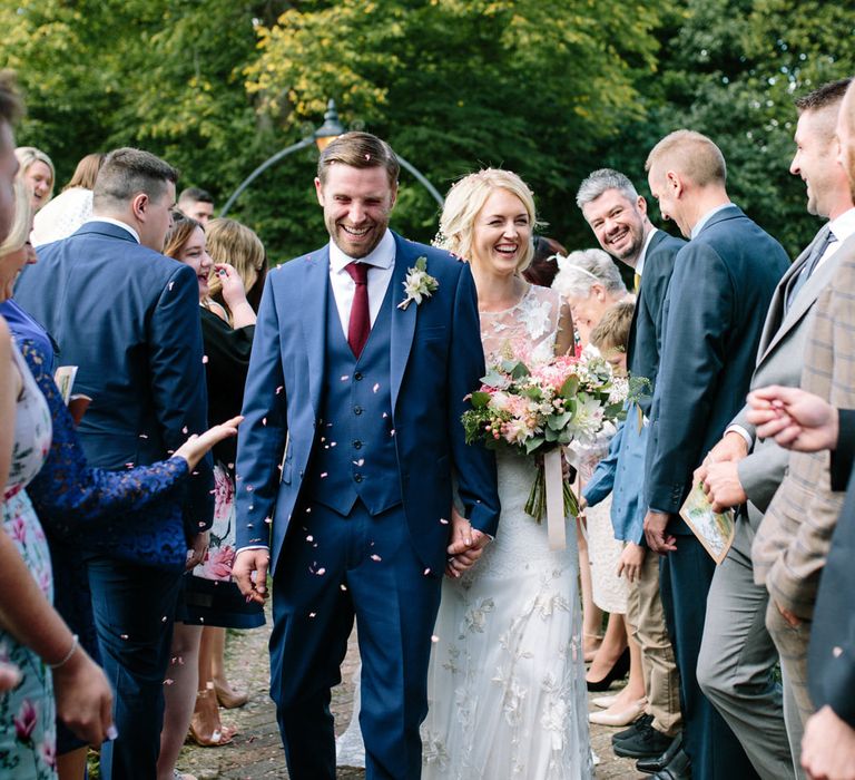 Confetti Moment | Bride in Claire Pettibone Whitney Bridal Gown with Cape | Groom in French Connection Navy Suit | DIY Country Wedding at Warborne Farm, Lymington | Camilla Arnhold Photography