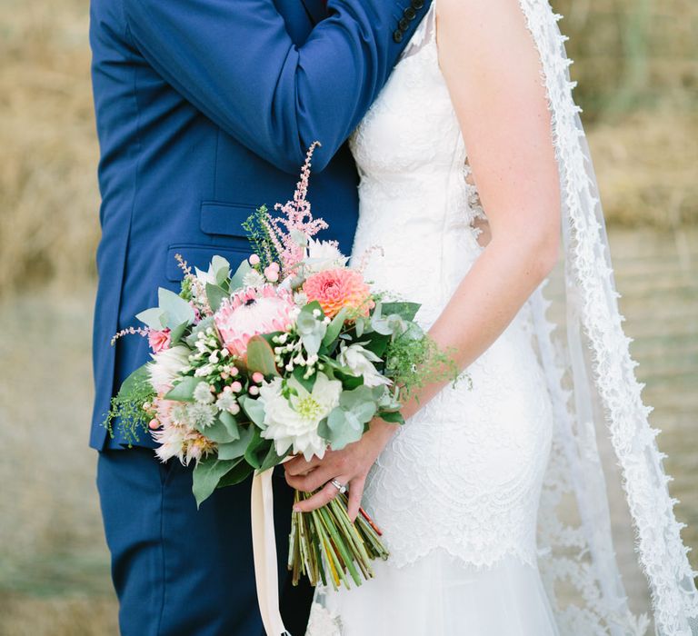 Bride in Claire Pettibone Whitney Bridal Gown with Cape | Groom in French Connection Navy Suit | DIY Country Wedding at Warborne Farm, Lymington | Camilla Arnhold Photography