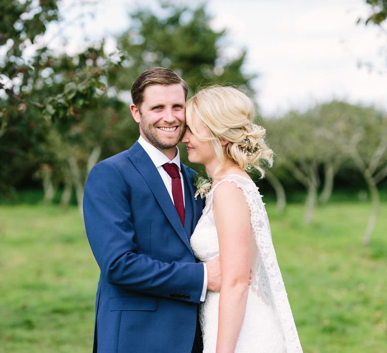 Bride in Claire Pettibone Whitney Bridal Gown with Cape | Groom in French Connection Navy Suit | DIY Country Wedding at Warborne Farm, Lymington | Camilla Arnhold Photography