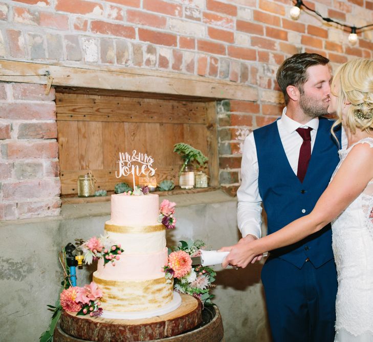 Cutting the Cake | Bride in Claire Pettibone Whitney Bridal Gown with Cape | Groom in French Connection Navy Suit | DIY Country Wedding at Warborne Farm, Lymington | Camilla Arnhold Photography