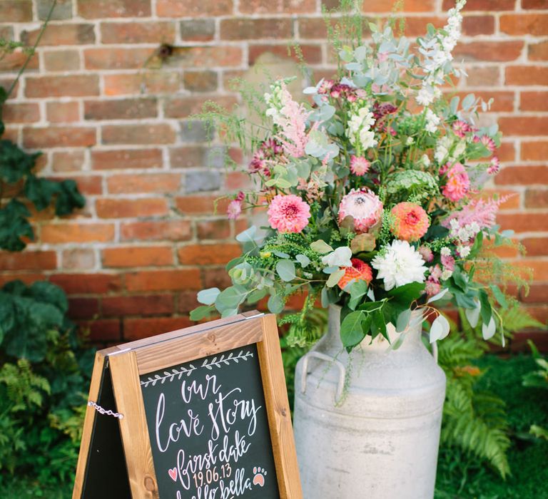 Milk Churn with Flowers and Black Board Wedding Sign | DIY Country Wedding at Warborne Farm, Lymington | Camilla Arnhold Photography