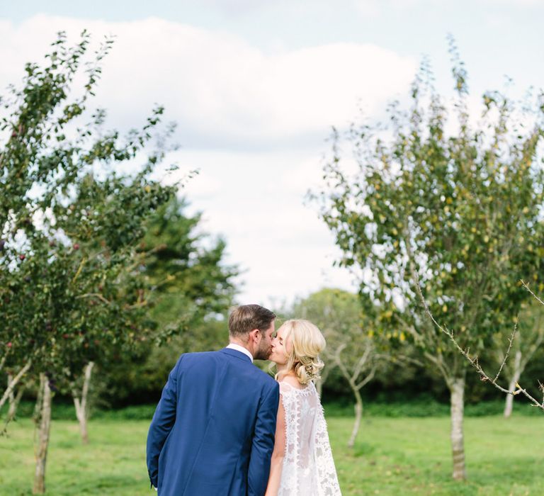 Bride in Claire Pettibone Whitney Bridal Gown with Cape | Groom in French Connection Navy Suit | DIY Country Wedding at Warborne Farm, Lymington | Camilla Arnhold Photography