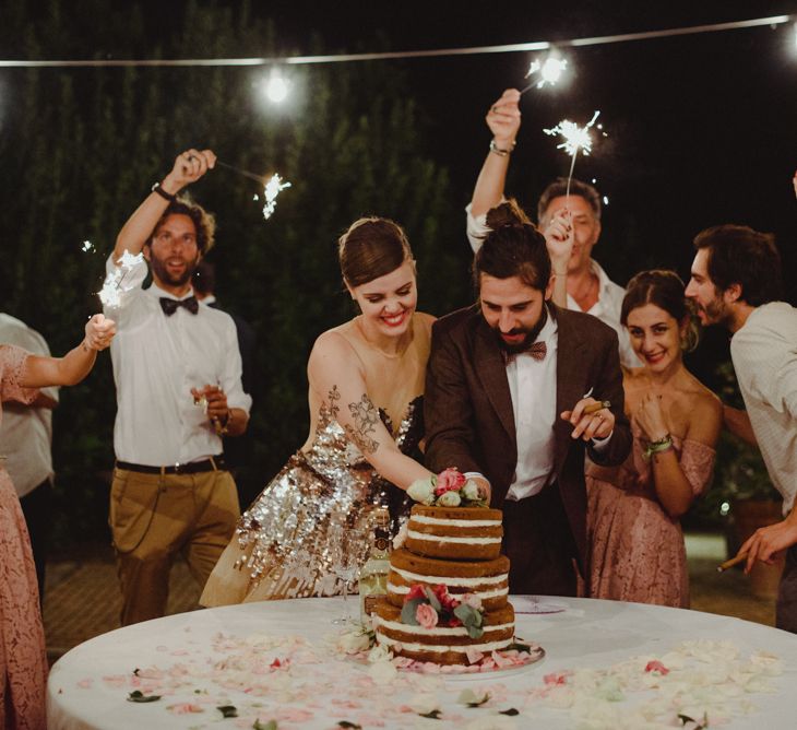 Cutting The Cake | Bride in Gold Glitter Second Dress | Groom in Brown Tweed Suit &amp; Bow Tie | Stylish Pink Wedding at Terzo di Danciano, Tuscany, Italy | Lucrezia Senserini Photography | Film by Righi Photography