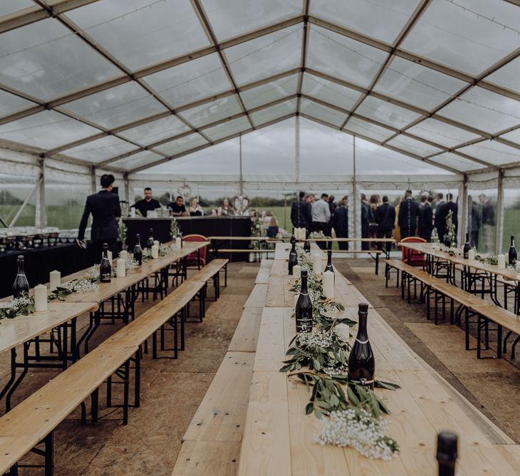 Trestle Tables Inside Glass Marquee Wedding Reception