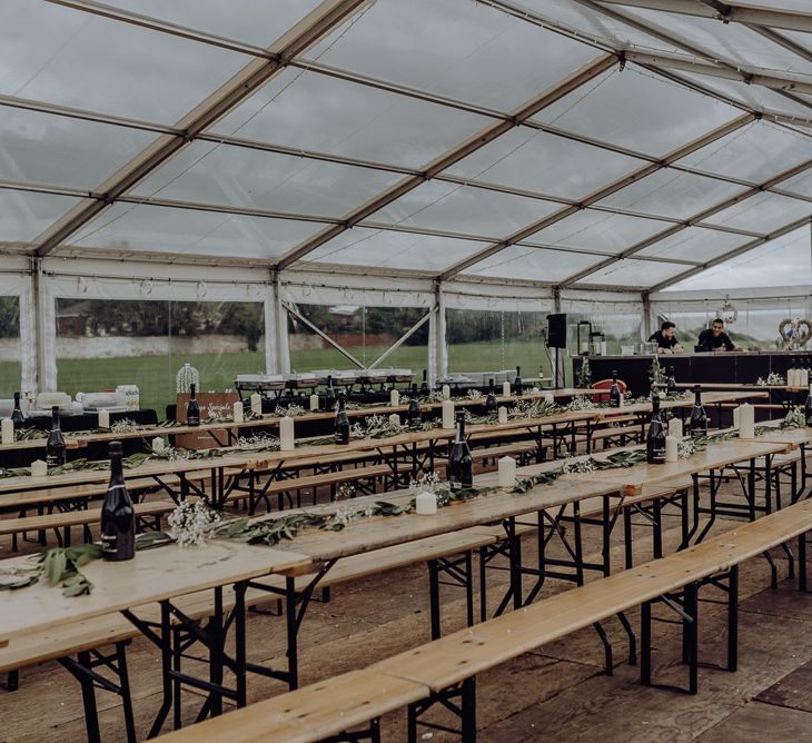 Trestle Tables with Greenery Garland and Church Flower Centrepieces