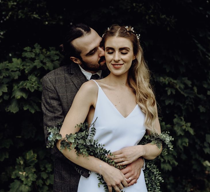 Groom in Bride Check suit Hugging Bride in Spaghetti Strap Wedding Dress