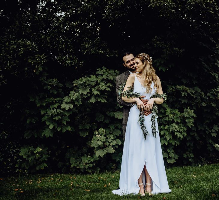 Boho Bride in Spaghetti Strap Wedding Dress and Ivy Garland with Groom in Brown Check Suit