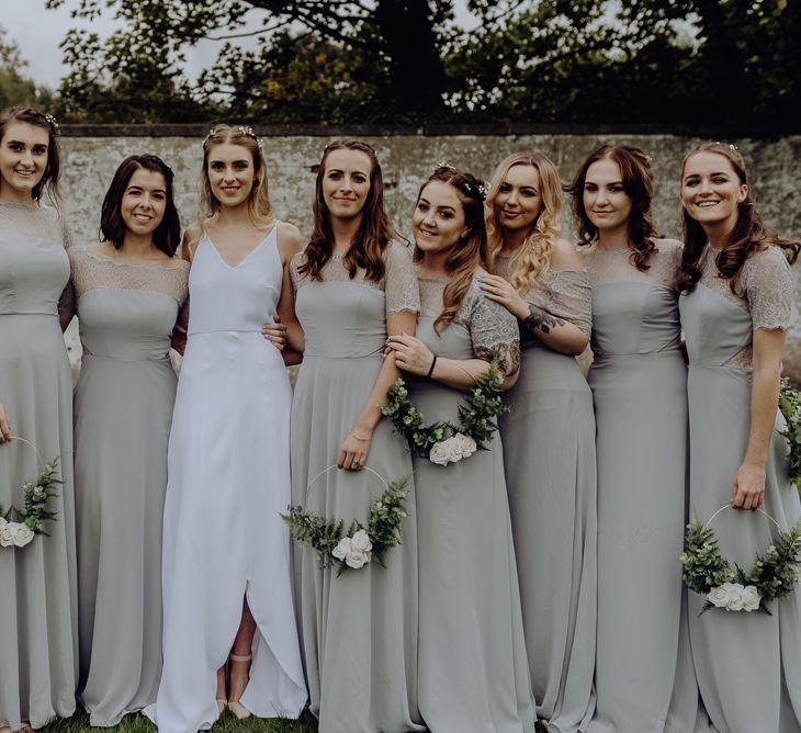 Large Bridal Party with Bridesmaids in Grey Dresses Holding DIY Flower Hoops and Bride in  Slip Wedding Dress