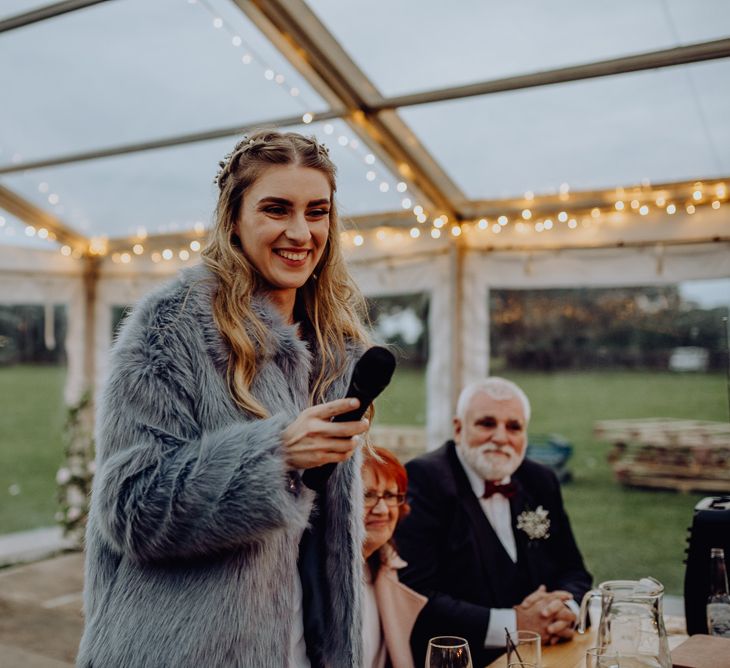 Bride in Grey Faux Fur Coat Giving Her Wedding Speech