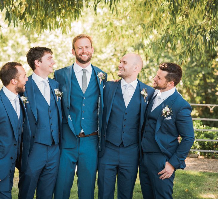 Groom in Royal Blue Three-Piece Suit from Moss Bros. with Silver Tie and Pocket Square from T.M.Lewin | Groomsmen in Royal Blue Moss Bros. Suits with Silver Ties and Pocket Squares from Tie Specialist UK | Dusty Pink and White Buttonholes Wrapped with Cappuccino Silk Ribbon | Smoke Bombs and Chinese Paper Fans Backdrop with Bride in Bardot Dress | Twig &amp; Vine Photography