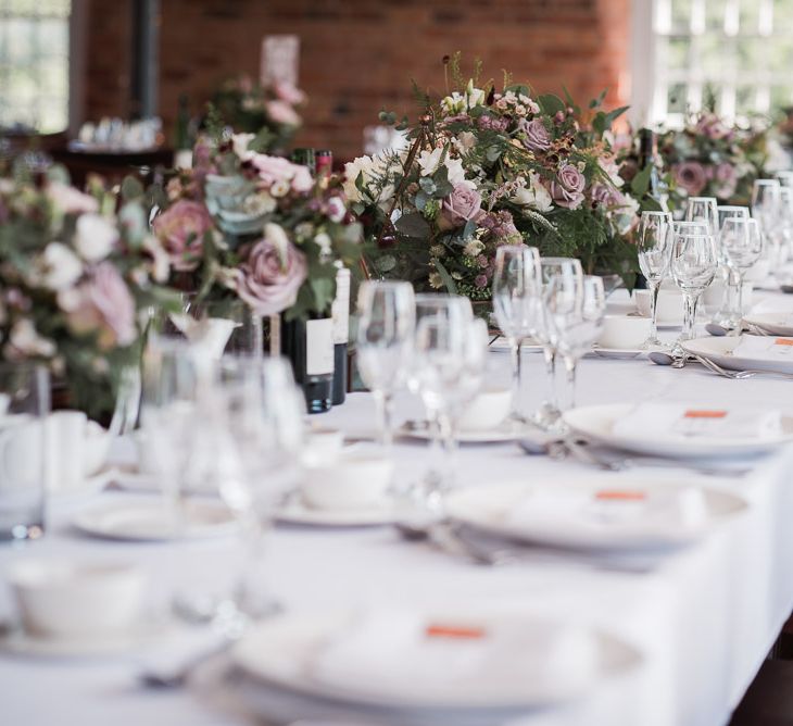 Dusky Pink Roses, White Peonies, Sweetpeas, Coffee-Coloured Phlox and Foliage in Hurricane Jars on Top Table | Wedding Reception at The West Mill | Smoke Bombs and Chinese Paper Fans Backdrop with Bride in Bardot Dress | Twig &amp; Vine Photography