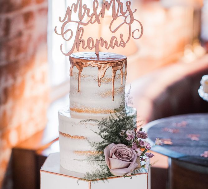 Three Tier Wedding Cake with Hexagon Bottom Layer and Semi-Naked Top Layers with Copper Drip Detail | Copper Calligraphy Cake Topper | Smoke Bombs and Chinese Paper Fans Backdrop with Bride in Bardot Dress | Twig &amp; Vine Photography