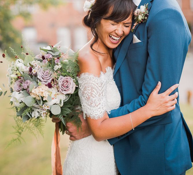 Bride in Lace Watters Dress with Bardot Neckline and Buttons Down Back | Bridal Up Do | Groom in Royal Blue Three-Piece Suit from Moss Bros. with Silver Tie and Pocket Square from T.M.Lewin | Bridal Bouquet of Dusky Pink Roses, White Peonies, Sweetpeas, Coffee-Coloured Phlox and Foliage Tied with Cappuccino Silk Ribbon | Smoke Bombs and Chinese Paper Fans Backdrop with Bride in Bardot Dress | Twig &amp; Vine Photography