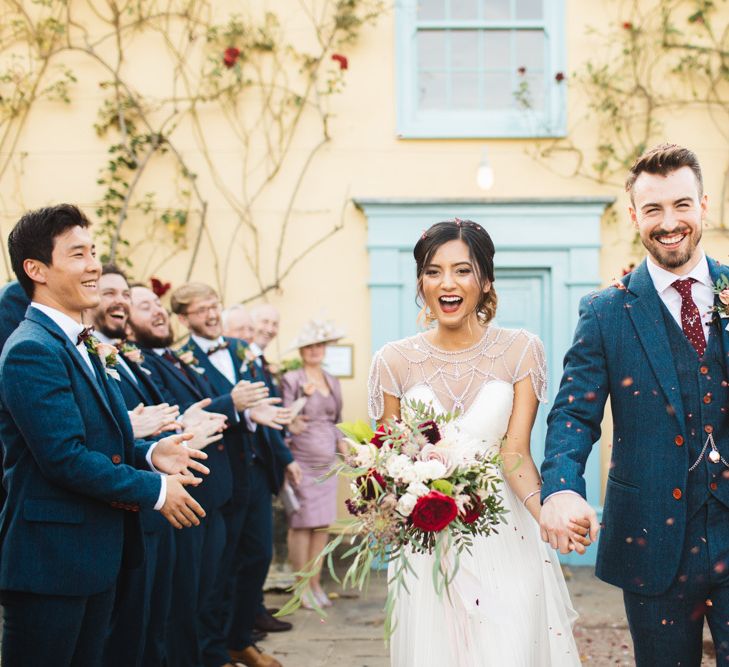 Confetti Portrait Throwing Over Bride and Groom