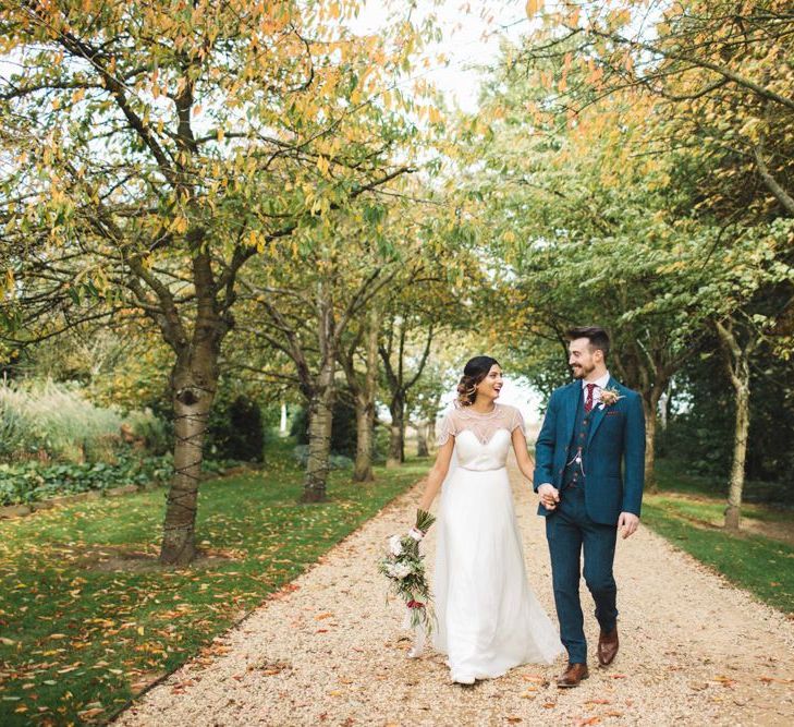 Bride and Groom After Ceremony in Beaded Bride Dress and Navy Tweed Suit