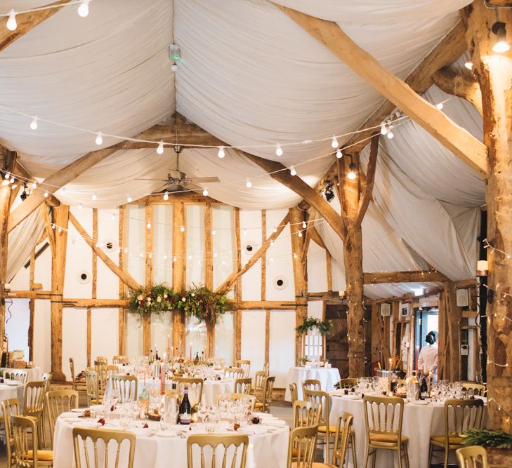 Barn Reception Wedding Venue with Rustic Decor and Pontoon Lighting