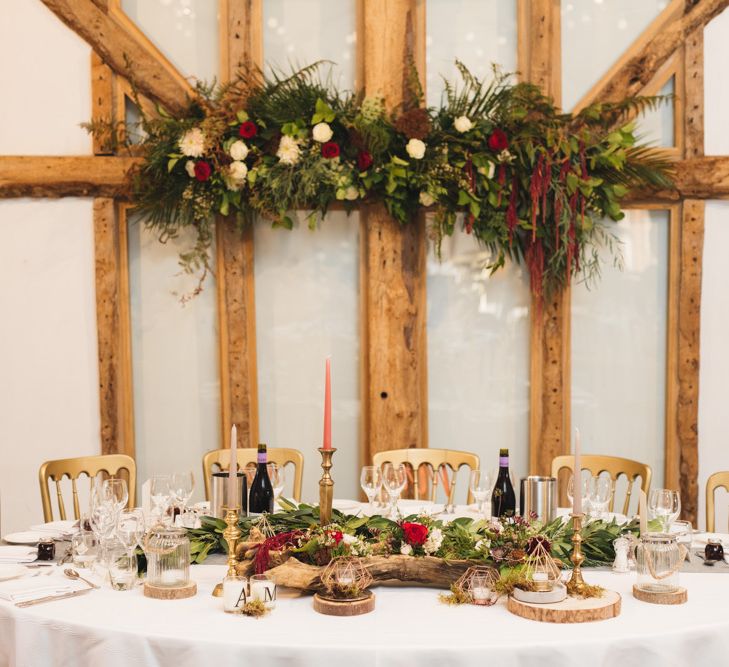 Autumnal Table Decor with Red Flowers and Candle Sticks