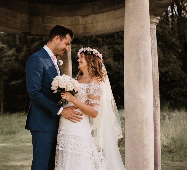 Bride and Groom In Lace Dress with Blush Bouquet and Groom in Grey Suit and Pink Tie