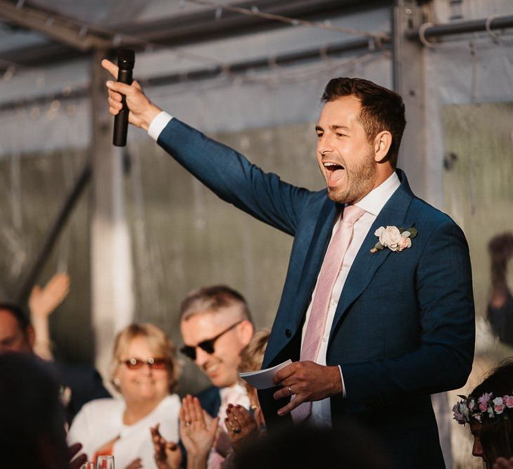 Groom Celebrating Whilst Making Speech During Reception