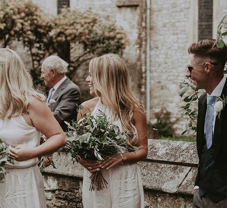 Bridesmaids in White Ghost Dresses with White and Green Bouquet Waiting at the Church