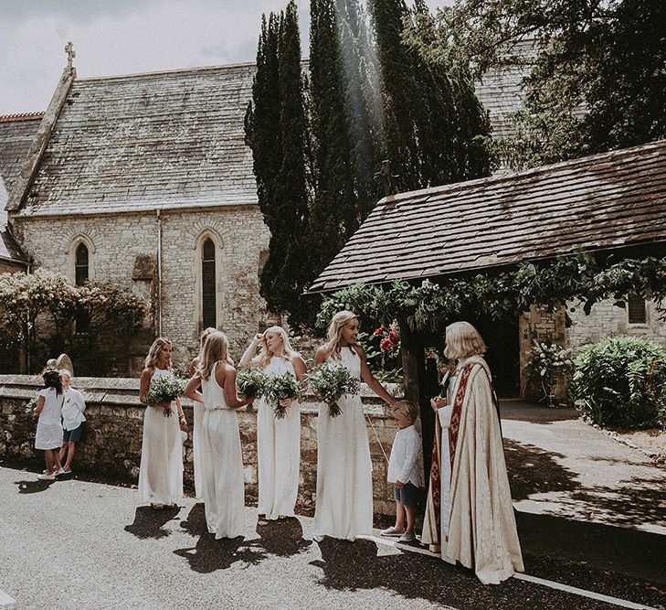 Bridesmaids in White Ghost Dresses Waiting Outside The Church for the Bride