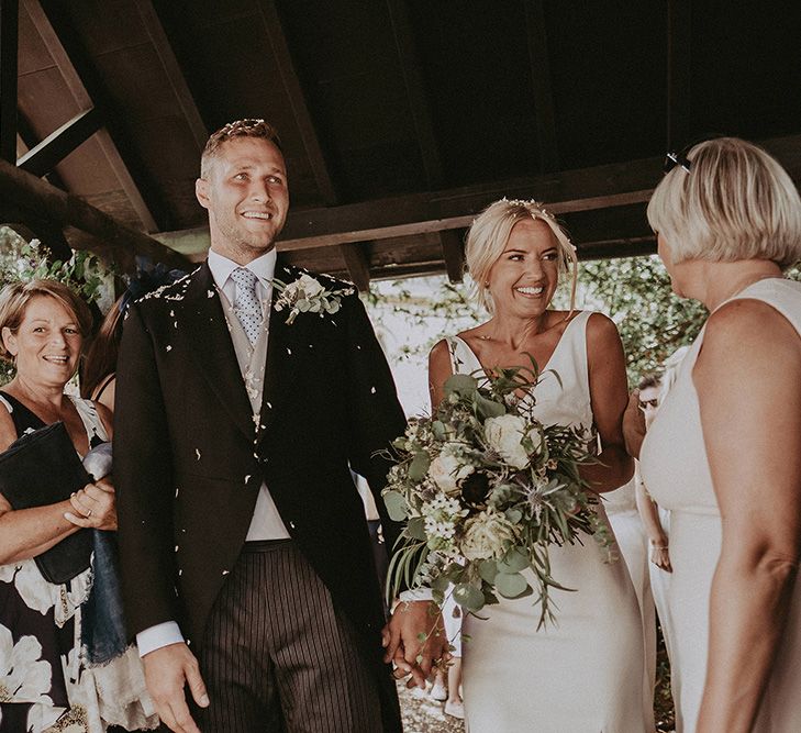 Confetti Moment with Bride in Rime Arodaky Wedding Dress and Groom in Traditional Morning Suit