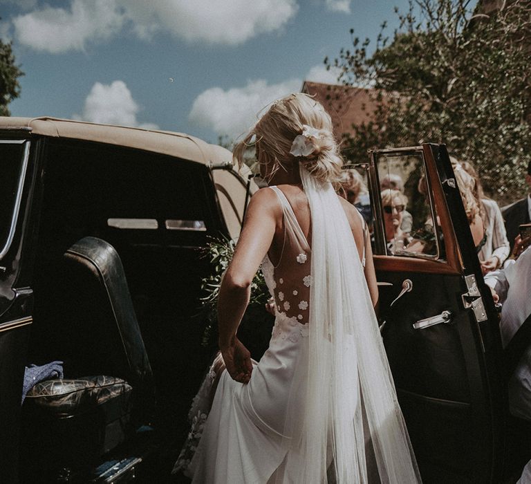 Bride Getting into The Wedding Car in a Rime Arodaky Wedding Dress with Cathedral Length Veil