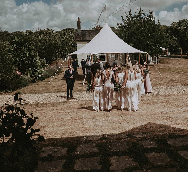 Bridal Party in White Dresses Walking Towards the Stretch Tent