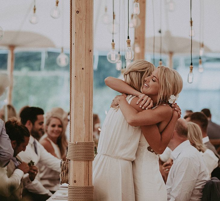 Bride and Bridesmaids Hugging During the Sperry Tent Reception