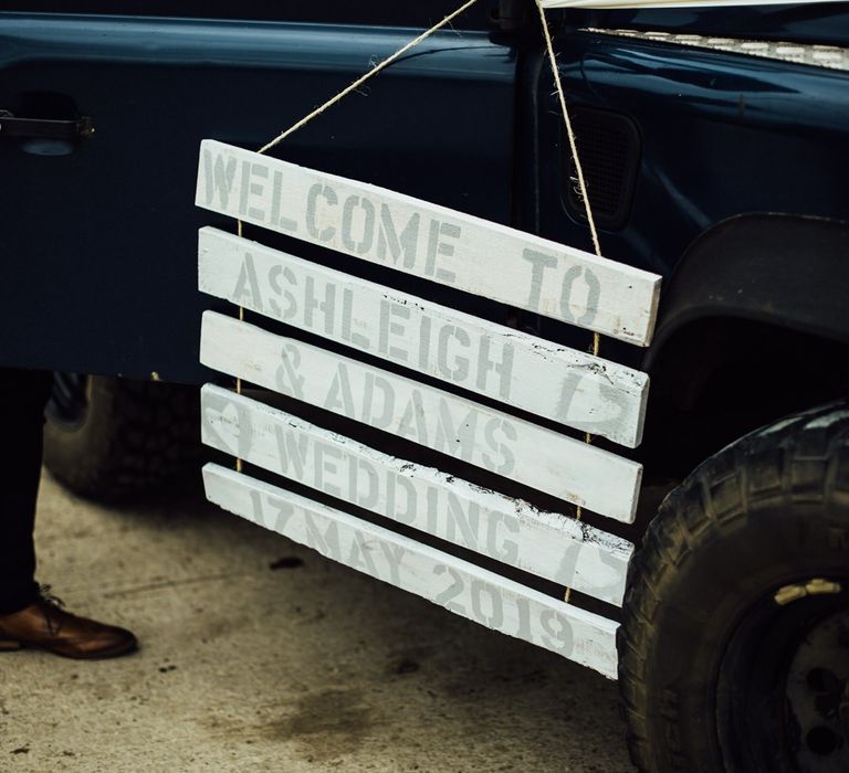 Wooden welcome sign for Oxfordshire barn wedding