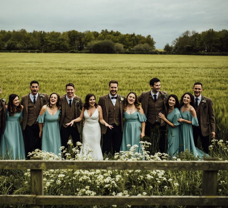 Bridal party and groomsmen amongst Oxfordshire barn wedding venue grounds