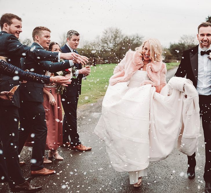 Confetti Exit | Bride in Organza Justin Alexander Gown &amp; Blush Pink Faux Fur Coverup | Groom in Black Tie Suit | Blush Pink &amp; Red, Christmas, Winter Wedding at Coltsfoot Country Retreat | Lemonade Pictures