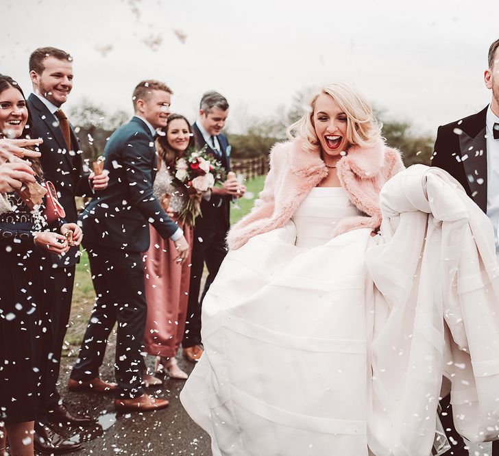 Confetti Moment | Bride in Organza Justin Alexander Gown &amp; Blush Pink Faux Fur Coverup | Groom in Black Tie Suit | Blush Pink &amp; Red, Christmas, Winter Wedding at Coltsfoot Country Retreat | Lemonade Pictures