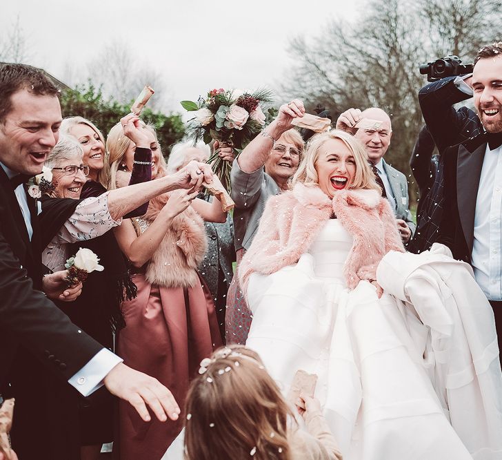 Confetti Moment | Bride in Organza Justin Alexander Gown &amp; Blush Pink Faux Fur Coverup | Groom in Black Tie Suit | Blush Pink &amp; Red, Christmas, Winter Wedding at Coltsfoot Country Retreat | Lemonade Pictures