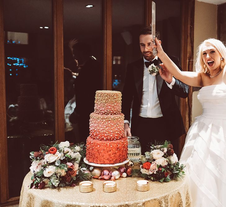 Cutting the Wedding Cake | Bride in Organza Justin Alexander Gown | Groom in Black Tie Suit | Blush Pink &amp; Red, Christmas, Winter Wedding at Coltsfoot Country Retreat | Lemonade Pictures