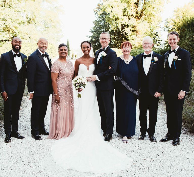 Portrait of the bride and groom with their immediate families