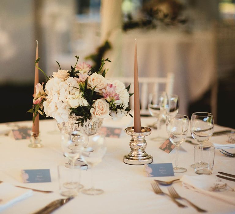 Elegant floral centrepiece and candlesticks for destination wedding with pink bridesmaid dresses