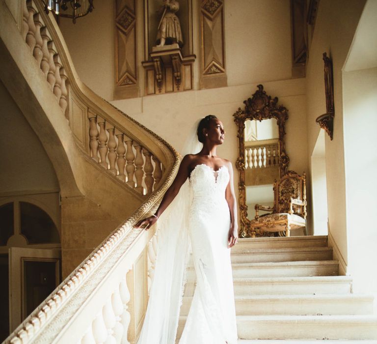 Bride in strapless Pronovias wedding dress standing on the stairs at Chateau La Durantie, France