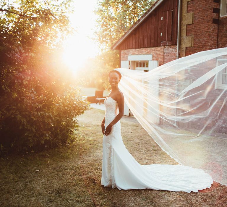 Bride in strapless wedding dress and billowing veil