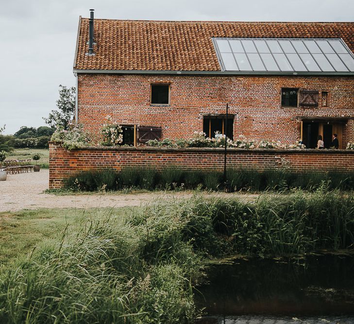 Abbey Hall Creative Space Wedding Venue | Outdoor Wedding Ceremony | 'Frida Kahlo' Flower Crown, Halfpenny London Bridal Separates and Colourful Bouquets with Peonies for Suffolk Wedding | From The Smiths Photography