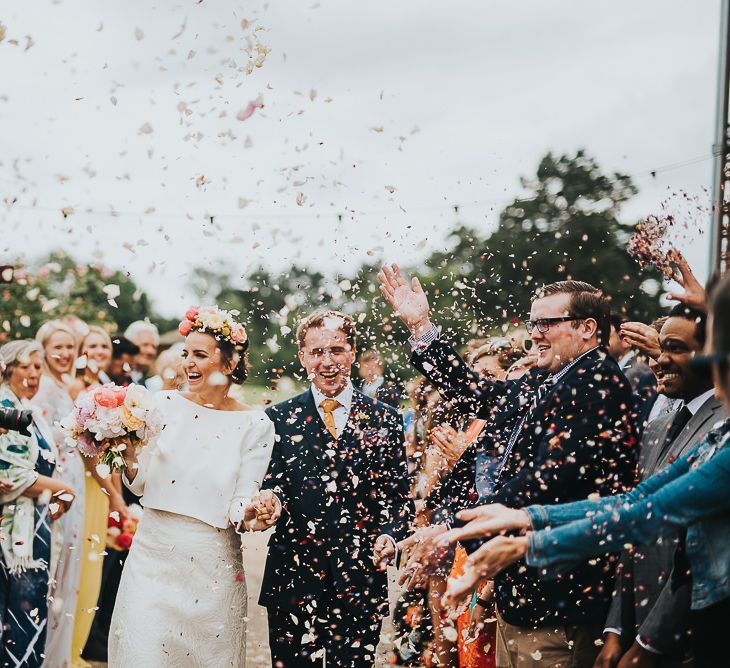 Bride in Halfpenny London Separates of Laura Top with Cowl Back and Long Sleeves, Silk Cami and Laser Cut Palm Skirt | Flower Crown with Pink Peony | Groom in Navy Tweed Suit by Walker Slater with Yellow Tie and Patterned Pocket Square | Colourful Bridal Bouquet of Pink and White Peonies | 'Frida Kahlo' Flower Crown, Halfpenny London Bridal Separates and Colourful Bouquets with Peonies for Suffolk Wedding | From The Smiths Photography