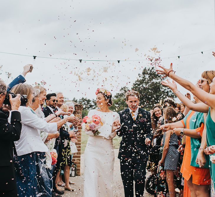 Bride in Halfpenny London Separates of Laura Top with Cowl Back and Long Sleeves, Silk Cami and Laser Cut Palm Skirt | Flower Crown with Pink Peony | Groom in Navy Tweed Suit by Walker Slater with Yellow Tie and Patterned Pocket Square | Colourful Bridal Bouquet of Pink and White Peonies | 'Frida Kahlo' Flower Crown, Halfpenny London Bridal Separates and Colourful Bouquets with Peonies for Suffolk Wedding | From The Smiths Photography