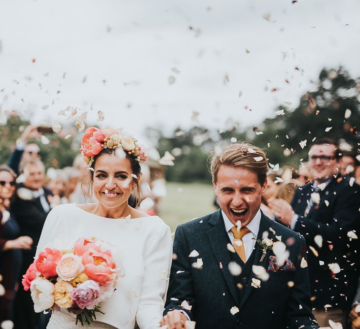 Bride in Halfpenny London Separates of Laura Top with Cowl Back and Long Sleeves, Silk Cami and Laser Cut Palm Skirt | Flower Crown with Pink Peony | Groom in Navy Tweed Suit by Walker Slater with Yellow Tie and Patterned Pocket Square | Colourful Bridal Bouquet of Pink and White Peonies | 'Frida Kahlo' Flower Crown, Halfpenny London Bridal Separates and Colourful Bouquets with Peonies for Suffolk Wedding | From The Smiths Photography