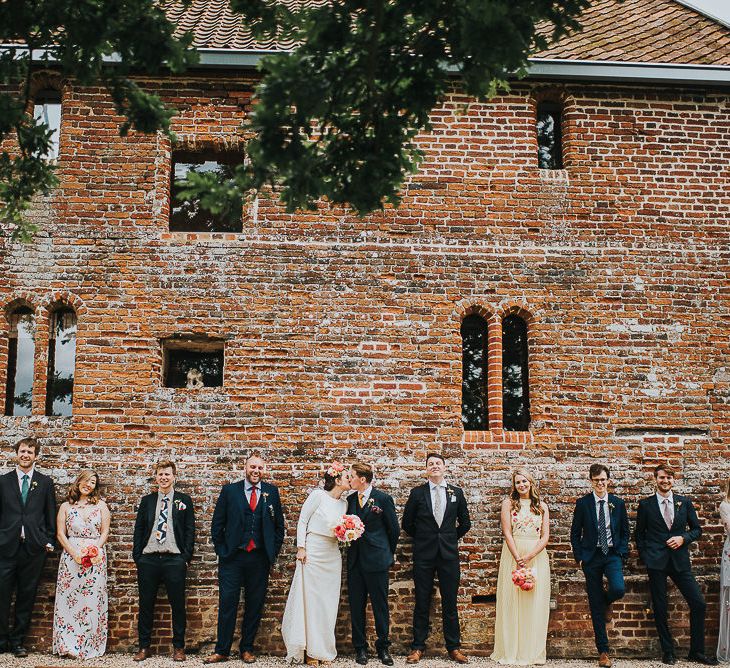 Bride in Halfpenny London Separates of Laura Top with Cowl Back and Long Sleeves, Silk Cami and Laser Cut Palm Skirt | Flower Crown with Pink Peony | Groom in Navy Tweed Suit by Walker Slater with Yellow Tie and Patterned Pocket Square | Bridesmaids in Mismatched Embroidered Dresses | Colourful Bouquets of Pink and White Peonies | 'Frida Kahlo' Flower Crown, Halfpenny London Bridal Separates and Colourful Bouquets with Peonies for Suffolk Wedding | From The Smiths Photography