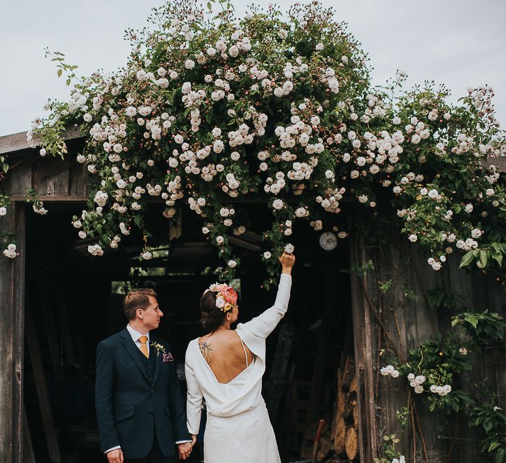 Bride in Halfpenny London Separates of Laura Top with Cowl Back and Long Sleeves, Silk Cami and Laser Cut Palm Skirt | Flower Crown with Pink Peony | Groom in Navy Tweed Suit by Walker Slater with Yellow Tie and Patterned Pocket Square | 'Frida Kahlo' Flower Crown, Halfpenny London Bridal Separates and Colourful Bouquets with Peonies for Suffolk Wedding | From The Smiths Photography