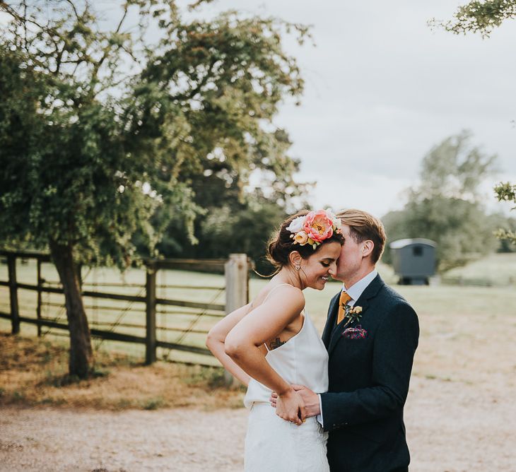 Bride in Halfpenny London Separates of Laura Top with Cowl Back and Long Sleeves, Silk Cami and Laser Cut Palm Skirt | Flower Crown with Pink Peony | Groom in Navy Tweed Suit by Walker Slater with Yellow Tie and Patterned Pocket Square | 'Frida Kahlo' Flower Crown, Halfpenny London Bridal Separates and Colourful Bouquets with Peonies for Suffolk Wedding | From The Smiths Photography