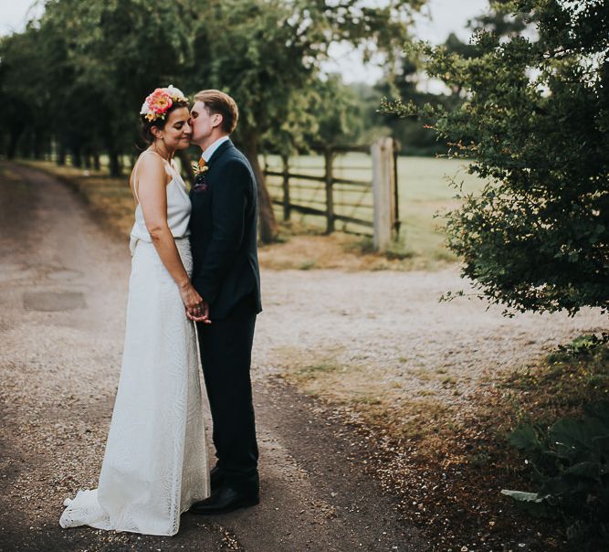 Bride in Halfpenny London Separates of Laura Top with Cowl Back and Long Sleeves, Silk Cami and Laser Cut Palm Skirt | Flower Crown with Pink Peony | Groom in Navy Tweed Suit by Walker Slater with Yellow Tie and Patterned Pocket Square | Colourful Bridal Bouquet of Pink and White Peonies | Suffolk Wedding | From The Smiths Photography