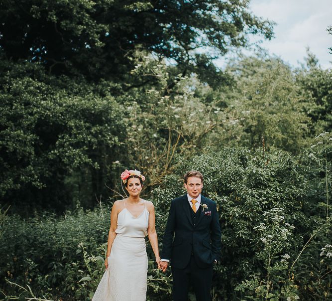 Bride in Halfpenny London Separates of Laura Top with Cowl Back and Long Sleeves, Silk Cami and Laser Cut Palm Skirt | Flower Crown with Pink Peony | Groom in Navy Tweed Suit by Walker Slater with Yellow Tie and Patterned Pocket Square | Colourful Bridal Bouquet of Pink and White Peonies | Suffolk Wedding | From The Smiths Photography