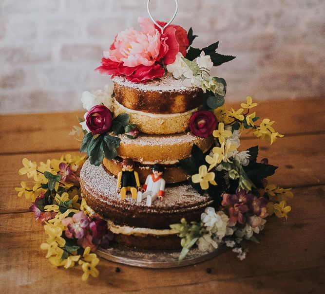 Three-Tier Naked Wedding Cake Decorated with Pink and Yellow Flowers and Lego Figures | 'Frida Kahlo' Flower Crown, Halfpenny London Bridal Separates and Colourful Bouquets with Peonies for Suffolk Wedding | From The Smiths Photography