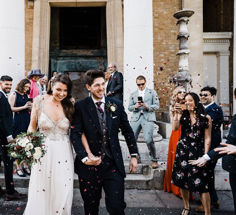 Confetti Exit with Bride Wearing Anna Campbell Wedding Dress With Beaded Detail